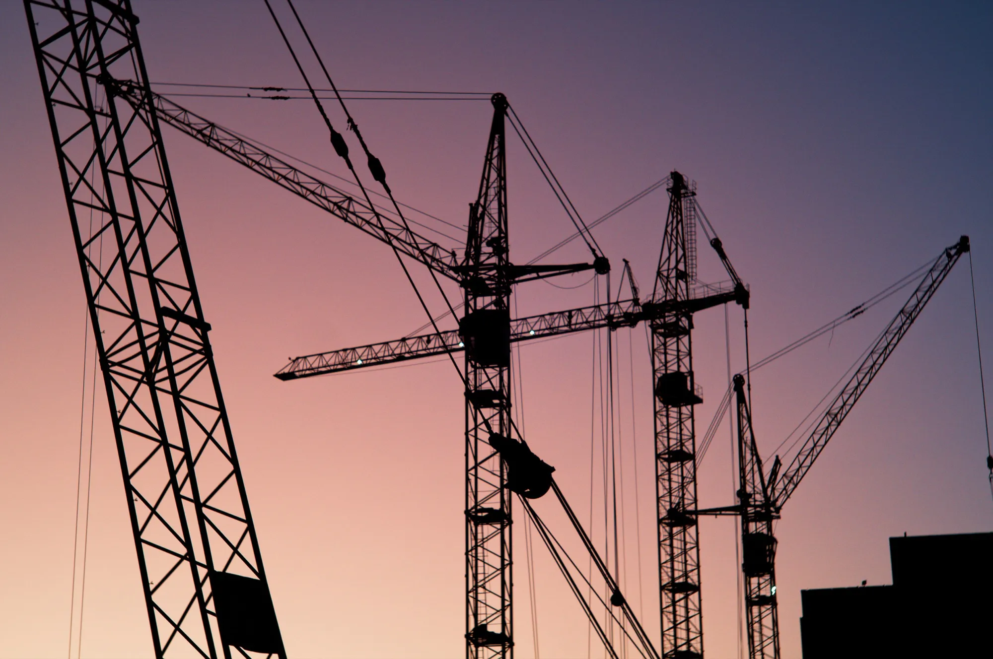 Aerial view of an active construction site with tower cranes